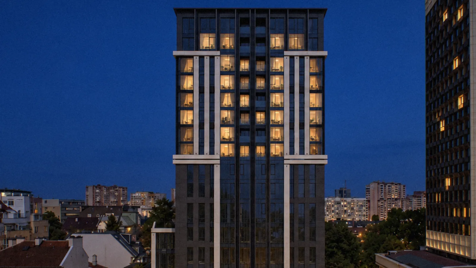 The tower at blue hour seen close, every window lit warm against the dark facade.