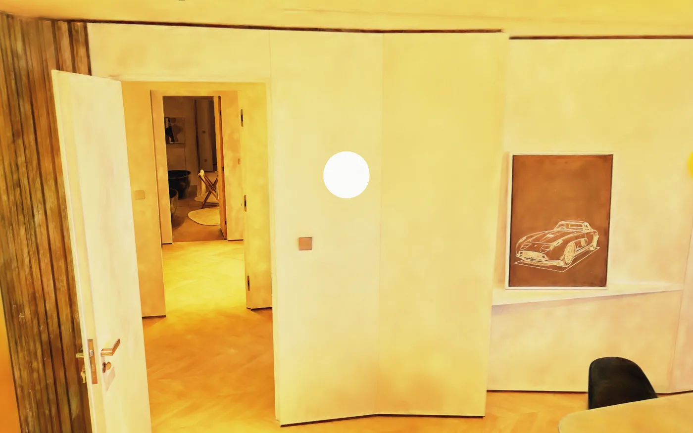 The same interior relit golden, walls saturated orange and the artwork frame reading warm brown.