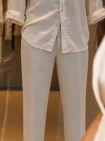 The same mannequin, frame, shirt and light, now in long linen trousers.